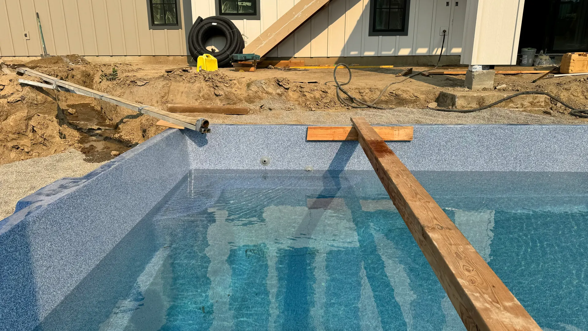 Fiberglass pool shell during backfill at a Waterscape jobsite