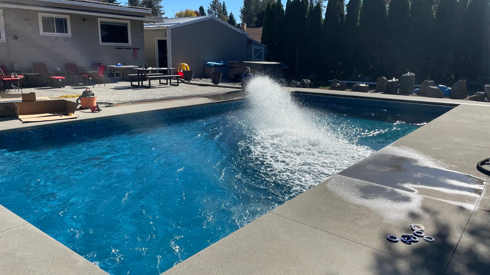Finished pool with a fountain return spraying into the surface