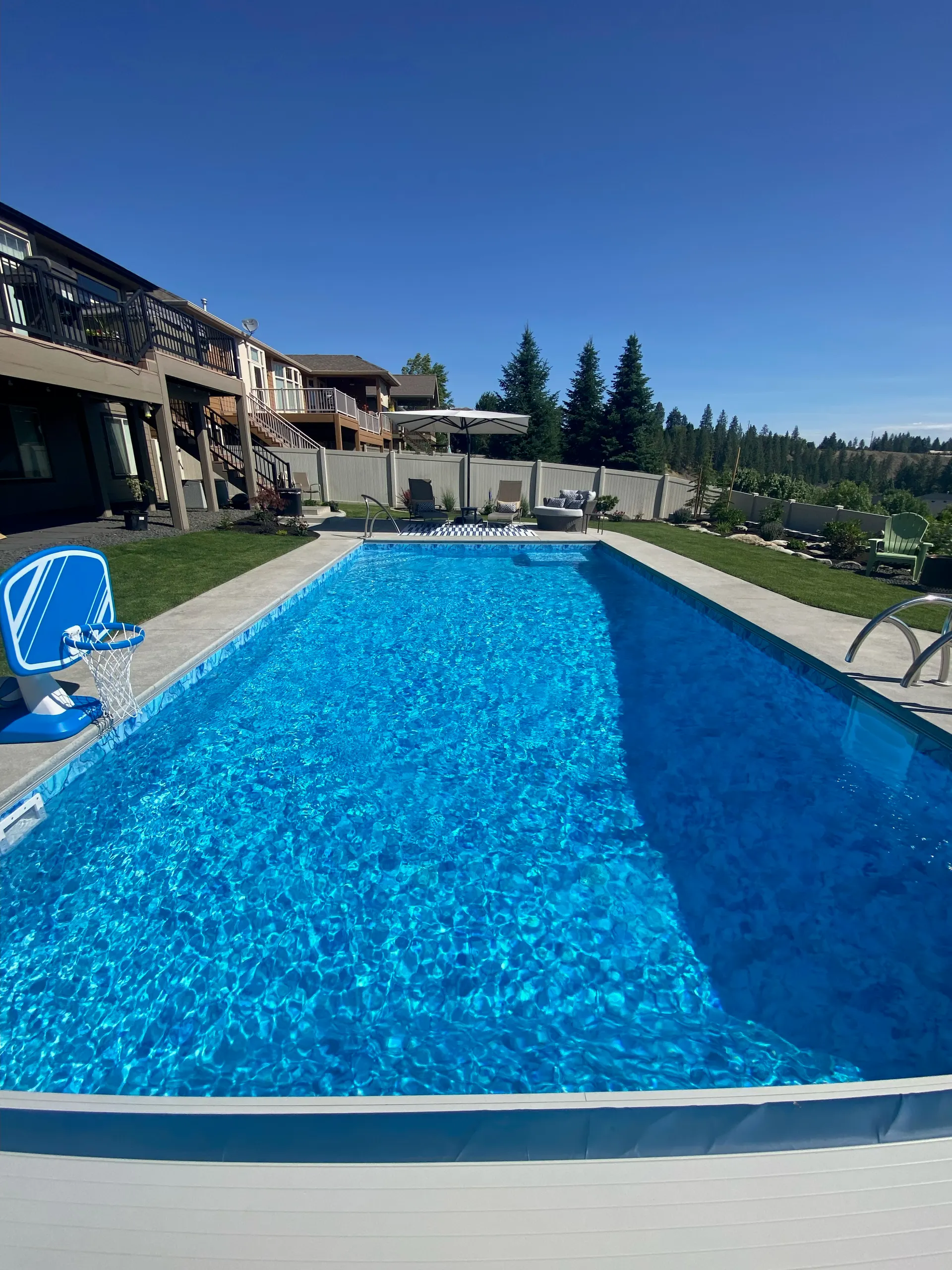 Hillside Spokane in-ground pool with lounger and pristine blue water