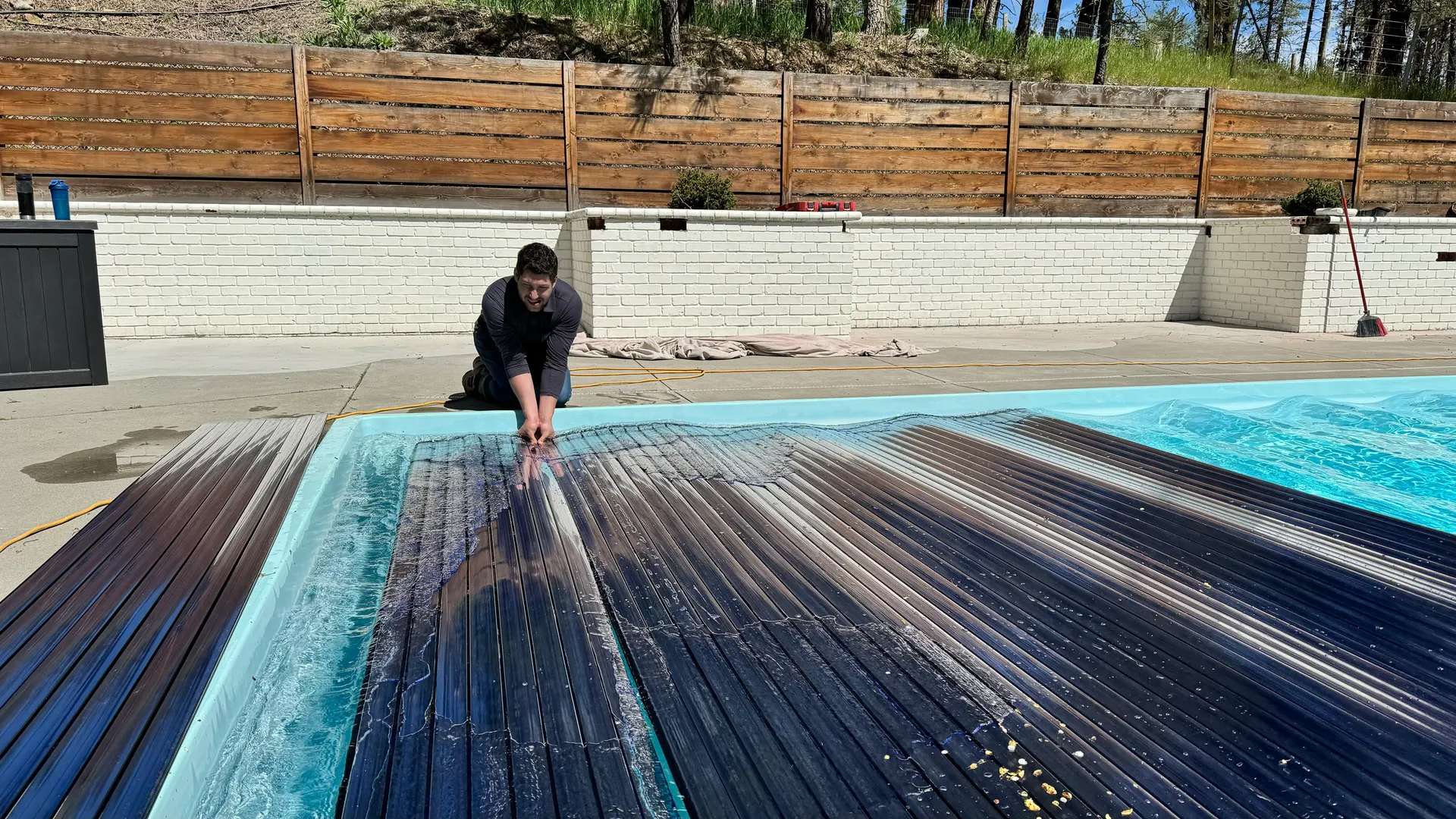 Pool with a dark automatic safety cover closed for off-season storage