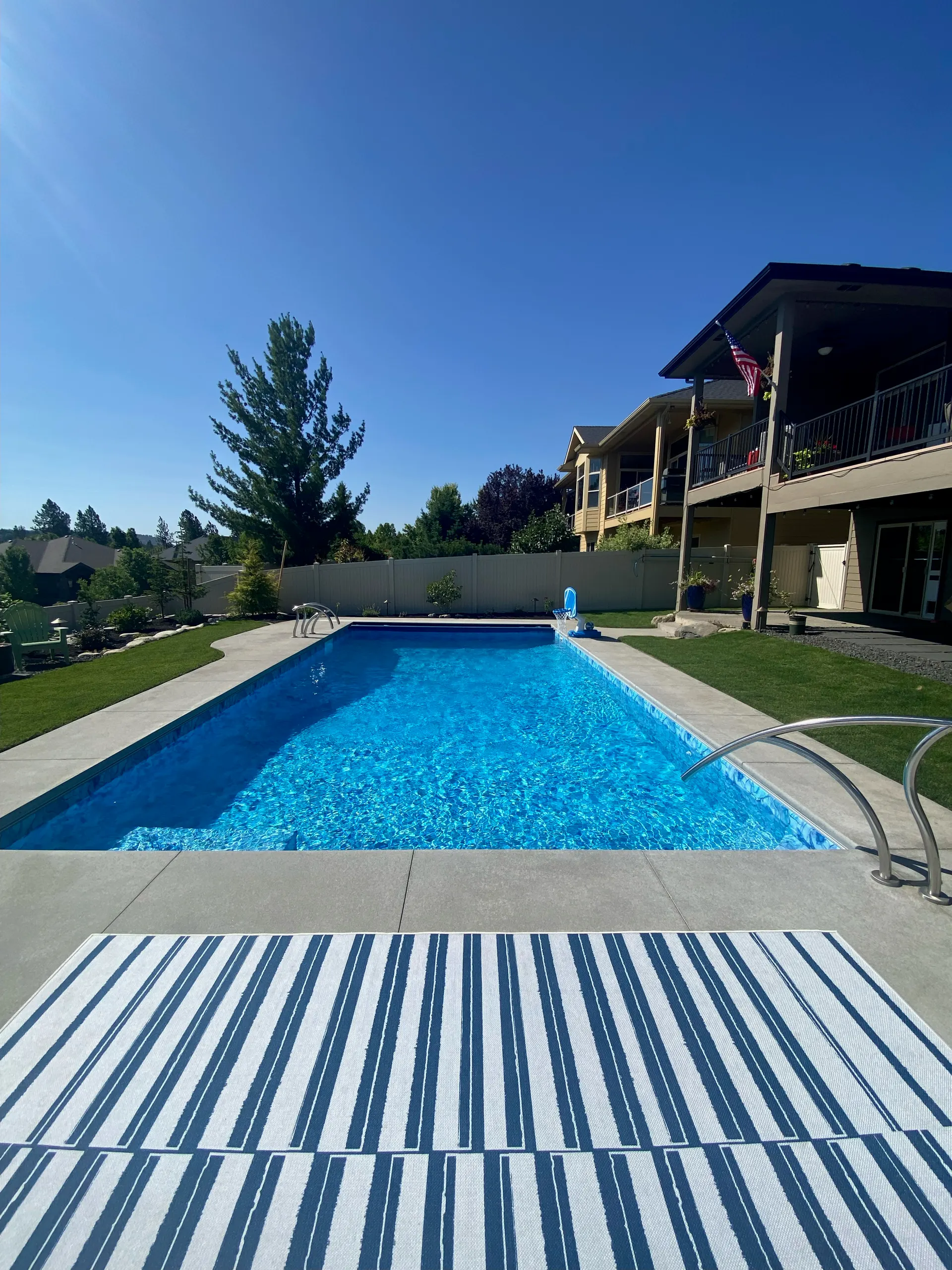 Long rectangular Spokane pool with white automatic-cover housing at the deep end