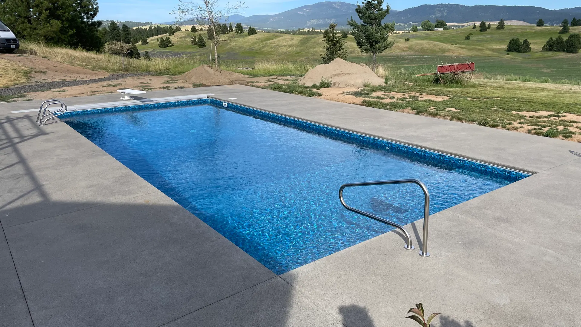 Rural backyard vinyl-liner pool with open landscape behind